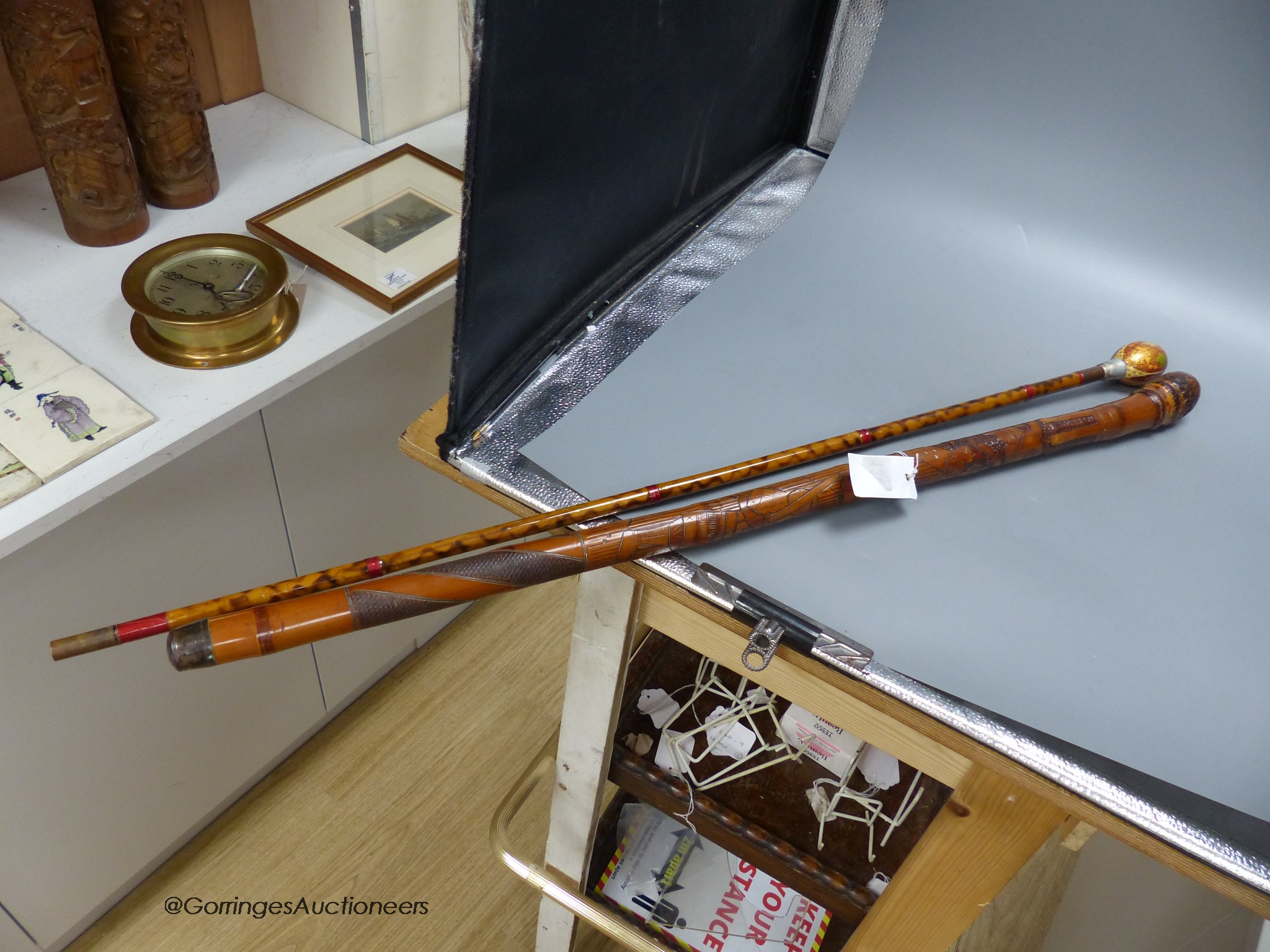 A Japanese carved bamboo walking stick and a Persian polychrome painted walking cane, tallest 97cm